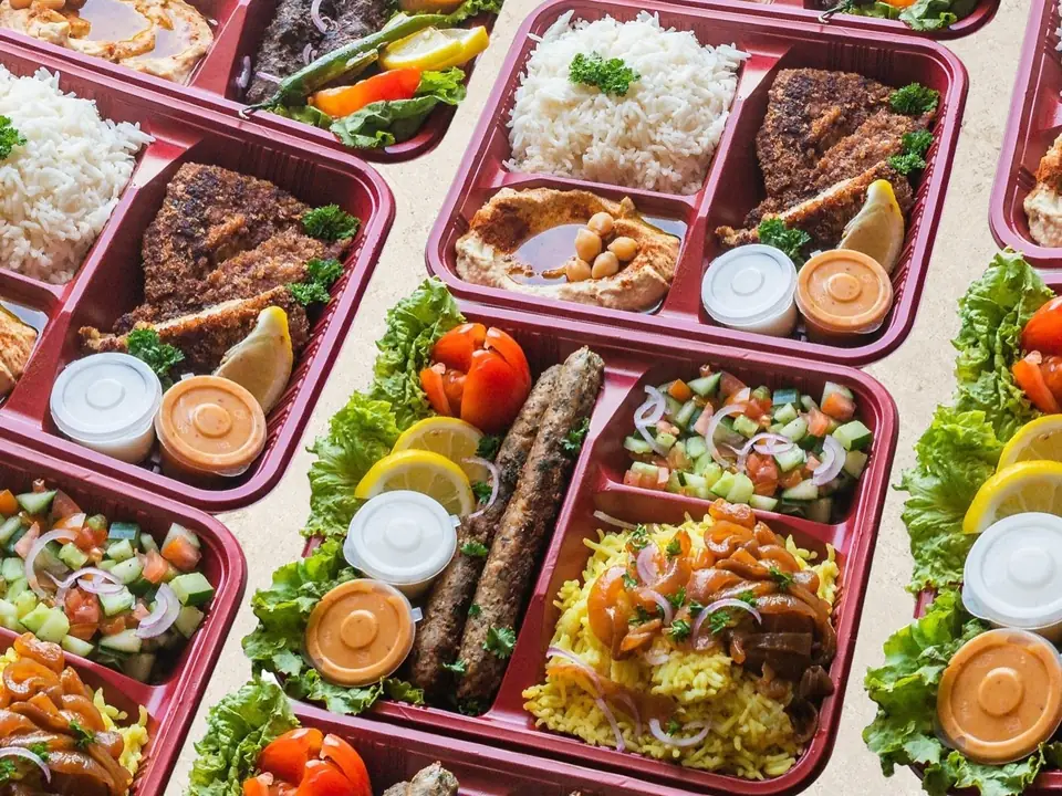 Rows of Sababa platters with basmati rice, kebab and salad